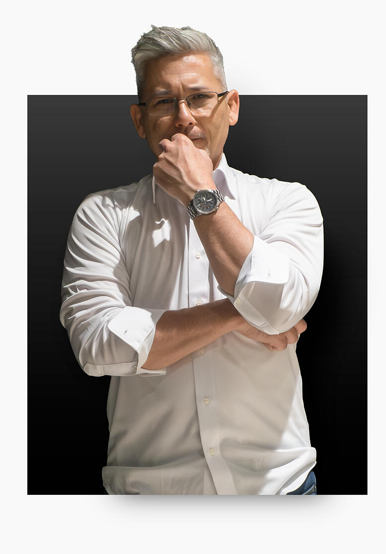 Ben Lindsey standing with arms crossed on black background